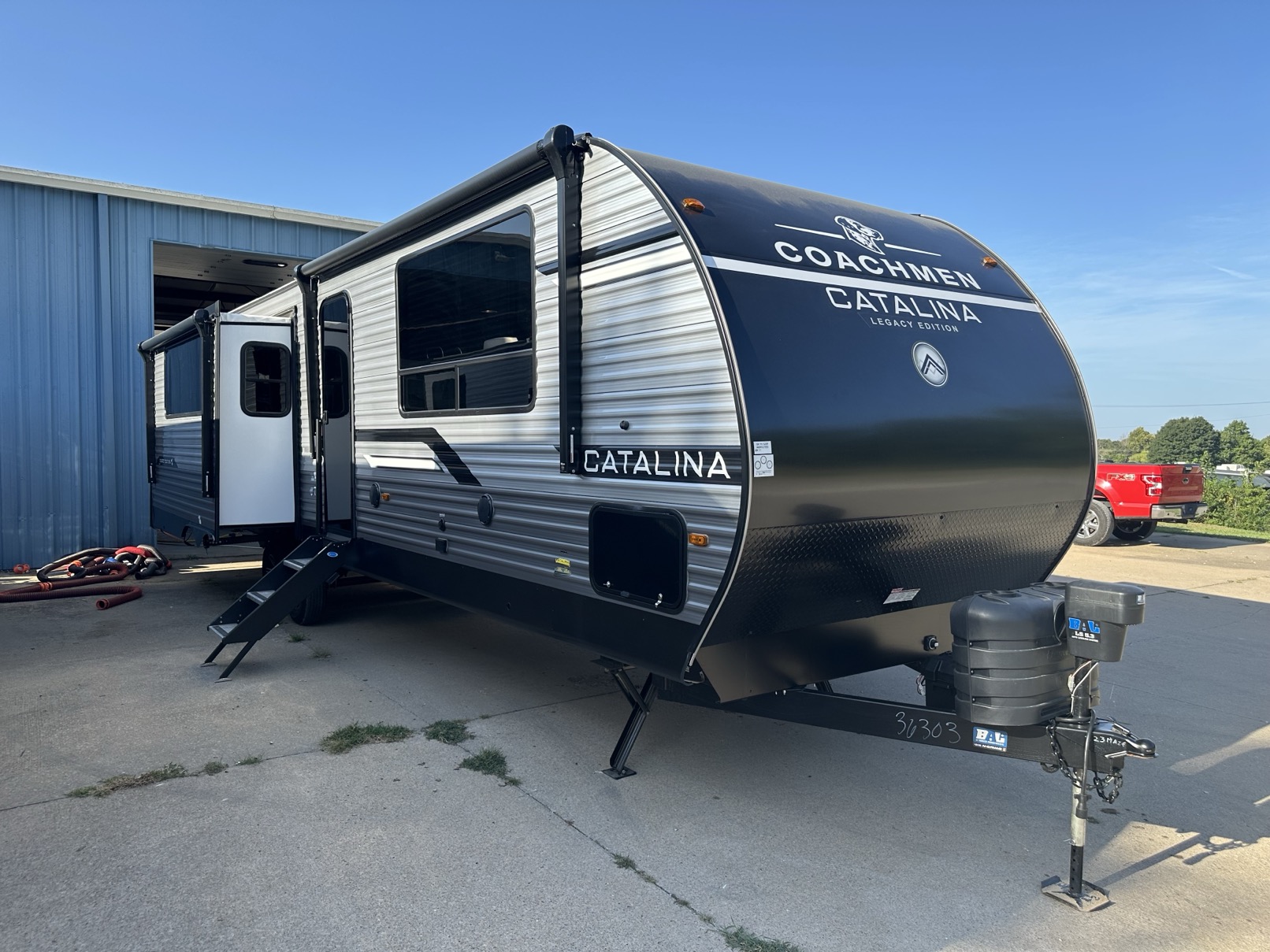 A new Coachmen Catalina travel trailer parked on a dealership lot